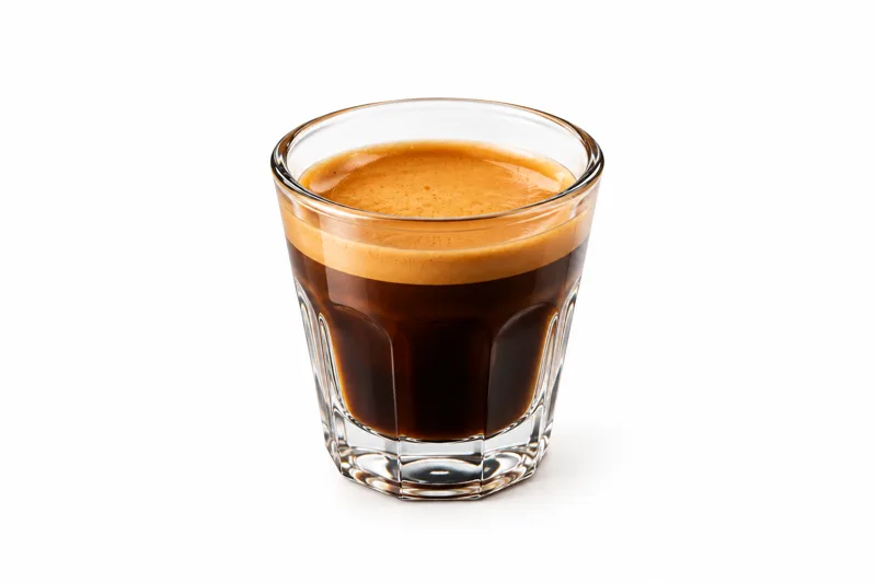 Double espresso shot with crema in a glass at Redondos Miami